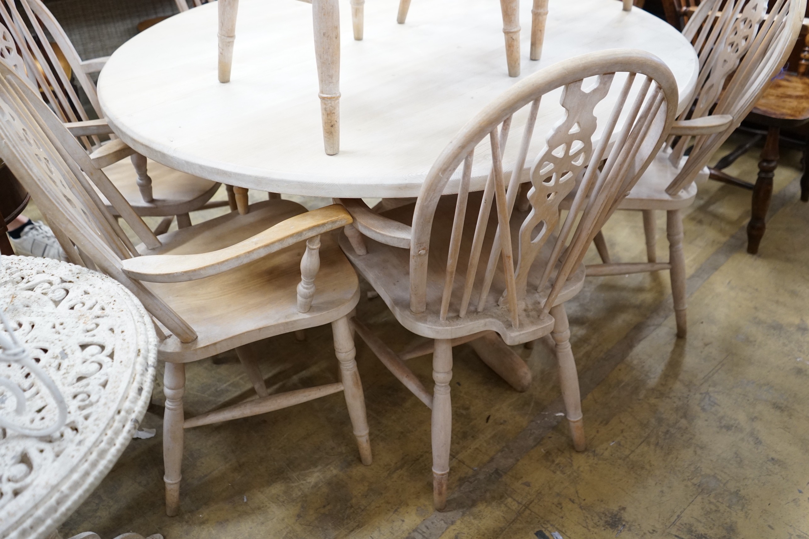 A set of eight Victorian style limed beech Windsor wheelback elbow chairs